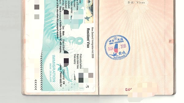 An official departure stamp inked onto a page of a travel document
