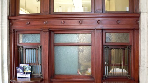 Customer service windows along the lobby wall of a small post office