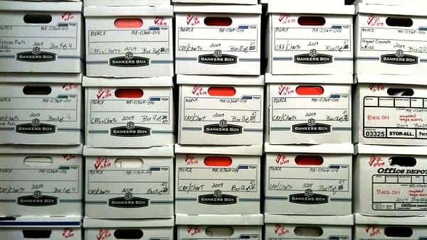 Stacks of cardboard archive boxes packed together on shelving