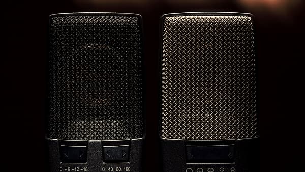 A close view of a condenser microphone showing its grille and pattern selector