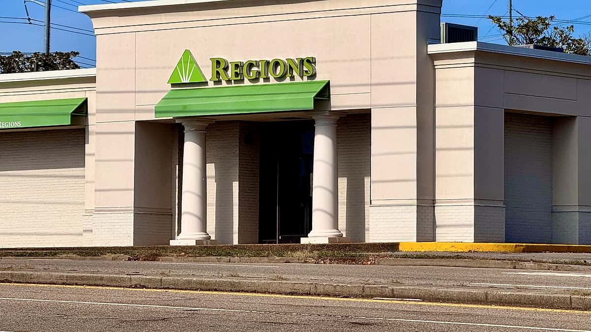 The exterior of a suburban bank branch photographed from the parking lot in daylight