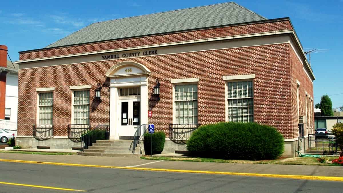 The exterior of a county clerk's office building on a small-town street