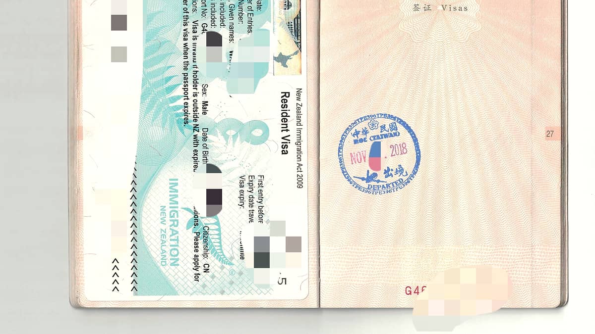 An official departure stamp inked onto a page of a travel document